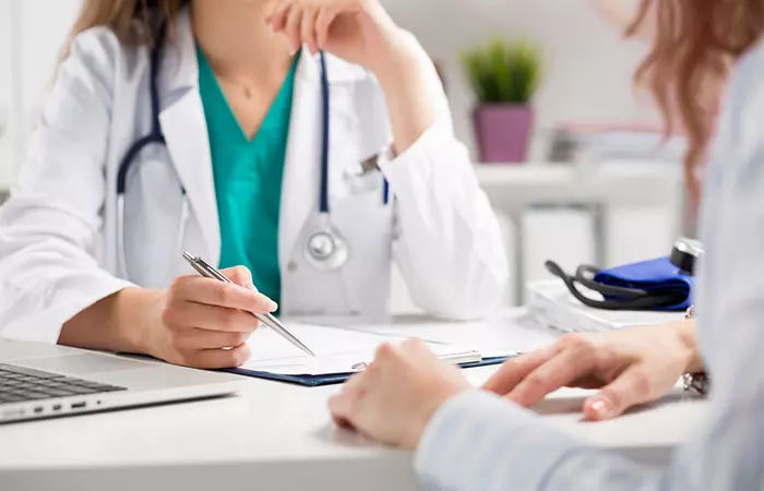 A close-up of a patient consulting a doctor for genital skin tags