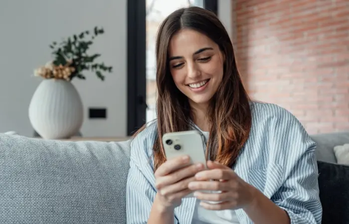 A happy woman looking at her phone