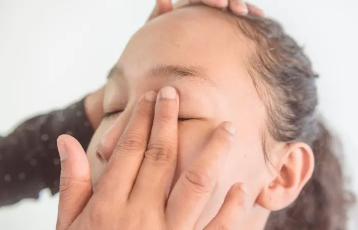 A makeup artist applying eye primer
