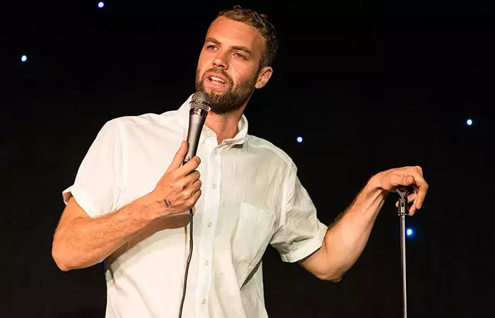 A stand-up comic at a 50th birthday party