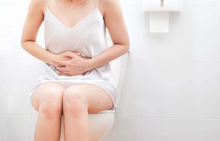 Woman experiencing diarrhea as a side effect of kabocha
