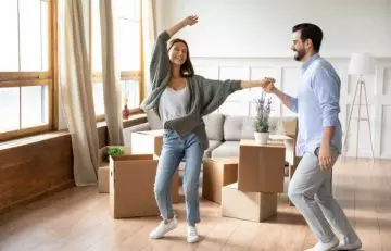 A man and woman engaged in a happy dance