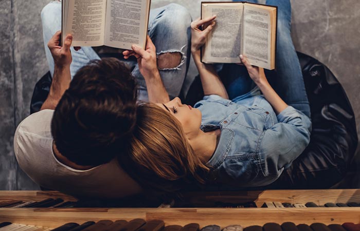 Adorable couple reading books together