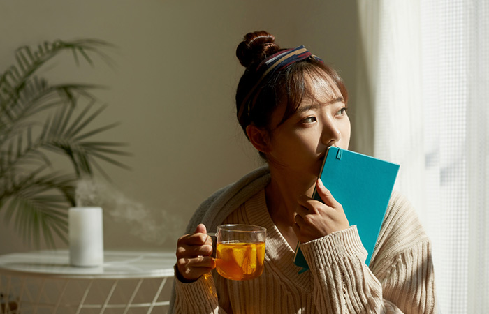Woman drinking kratom tea for its antidepressant effects