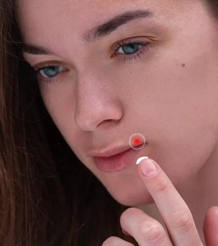 Girl applying ointment on her face