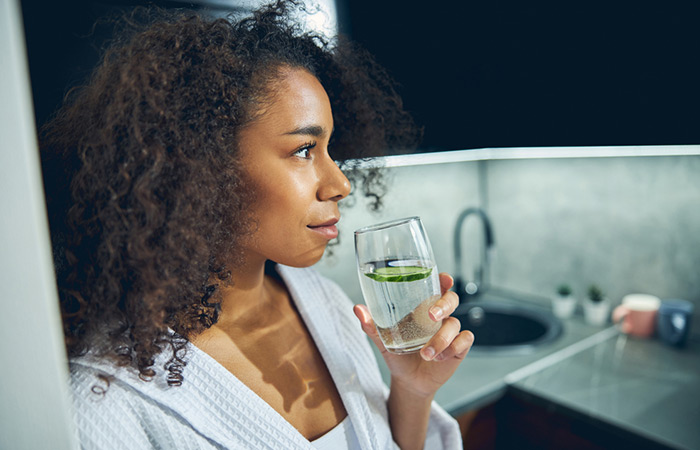 Woman drinking the right amount of cucumber water for good health