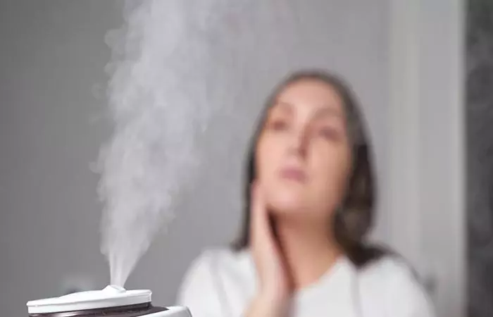 Woman using humidifier