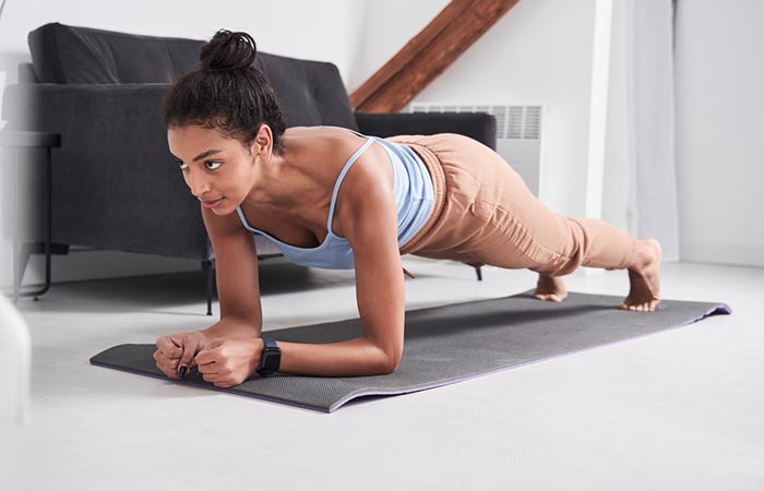 Woman holding a plank to lower blood pressure
