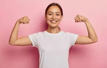 Woman flexing healthy muscles gained due to wheat germ consumption