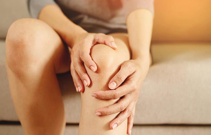 Woman massaging her weak knee