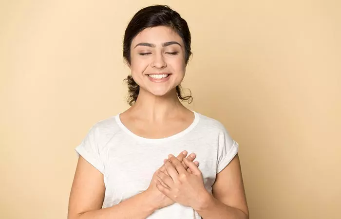 Woman with hands on her chest to indicate a healthy heart