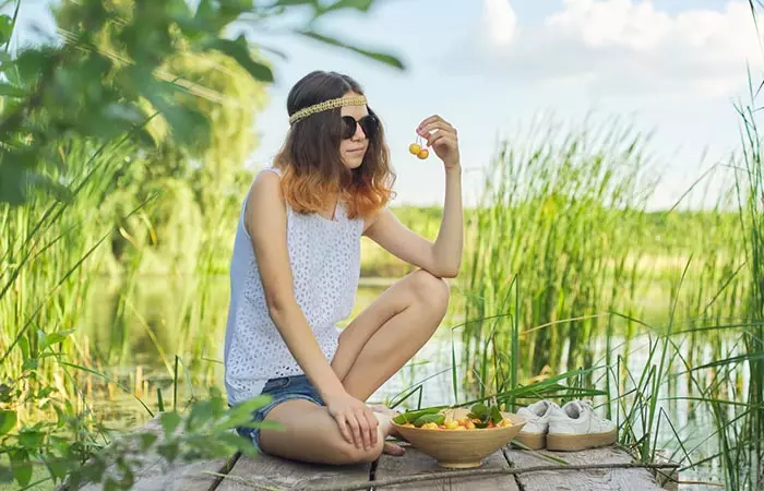 Woman eating nance fruits