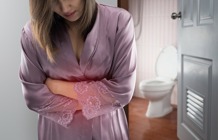 Woman experiencing IBS for annatto side effect