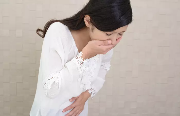 Woman feeling nauseous after having amino acid supplement