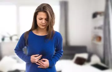 Women experiencing bloating and indigetion due to cucumber water consupmtion
