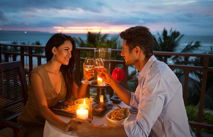 A beautiful couple enjoying dinner on a gorgeous open deck
