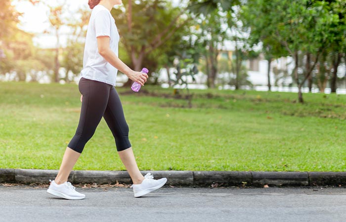 Woman walking as an exercise to lower blood pressure
