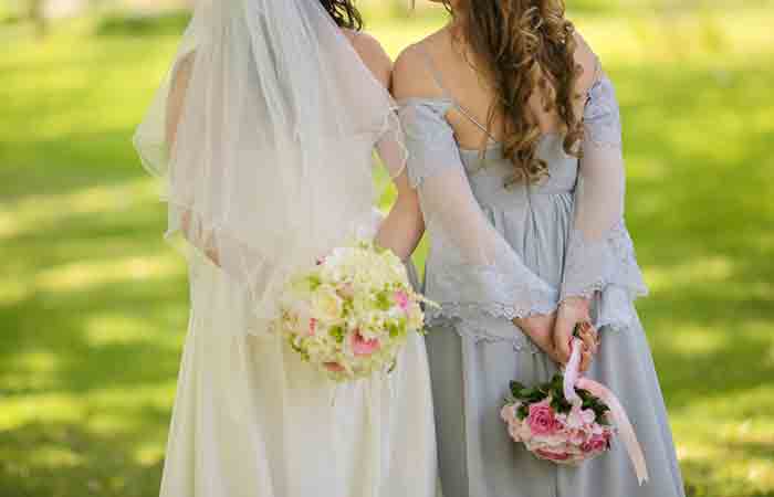 Bride standing with her maid of honor