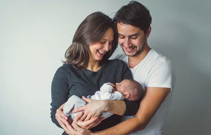 woman-man-holding-newborn-mom-dad