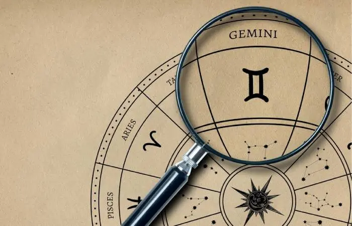 A magnifying glass placed over the Gemini sun sign on an Astrology chart