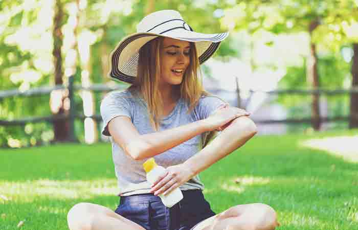 Woman applying sunscreen to avoid sun rash