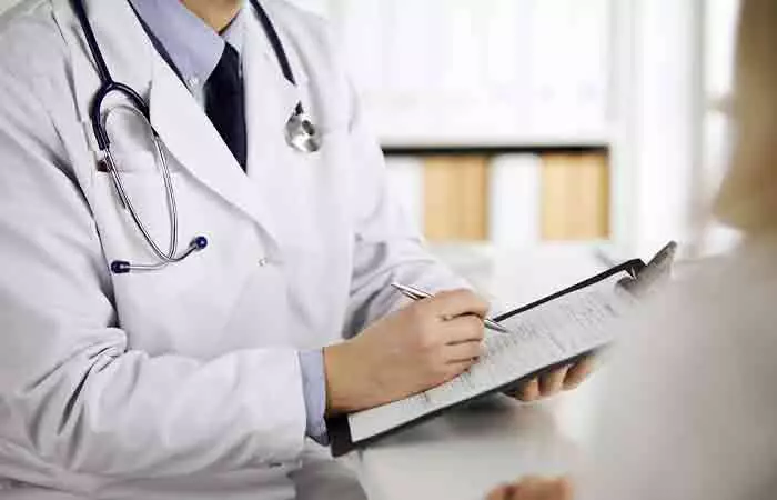 Doctor making notes during a physical examination for cyanosis