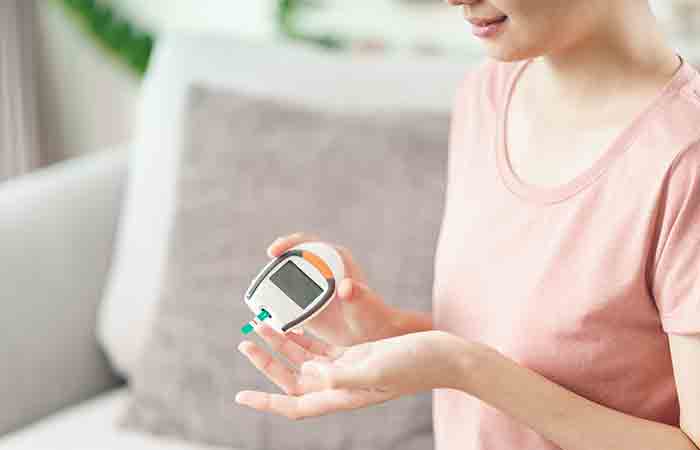 Woman checking blood glucose level