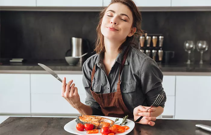 Woman eating swai fish to promote heart health