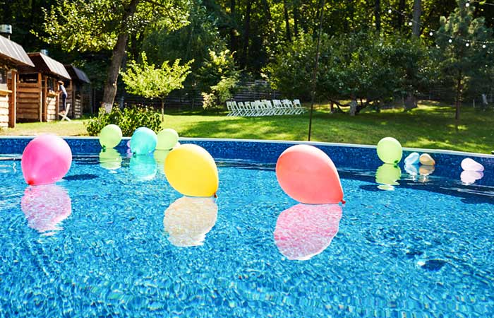 Throw some colorful balloons in the pool for your birthday party