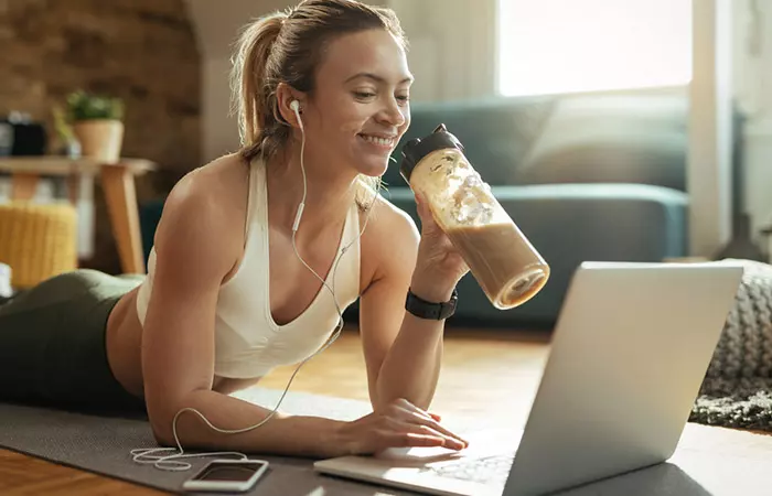 Woman drinking glucerna from a sipper between workout session