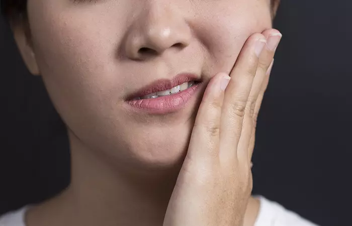 Woman experiencing swollen mouth due to popcorn