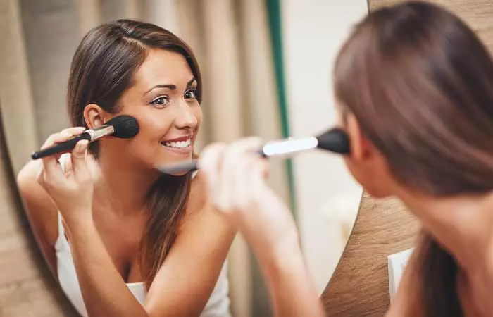 Smiling-While-Applying-Blush