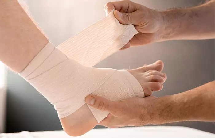 Wrapping sprained ankle with a bandage