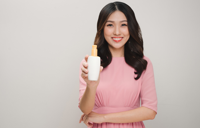 Woman holding an undecylenic acid lotion