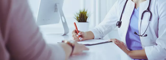 Woman consulting a dermatologist for ear eczema.