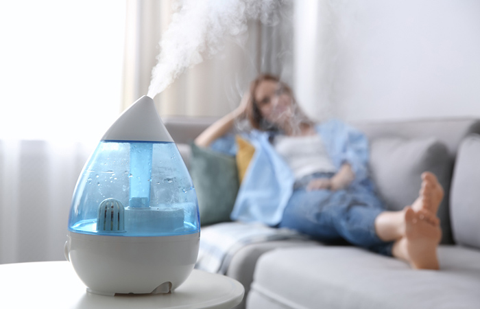 Woman using humidifier to reduce tickle in throat