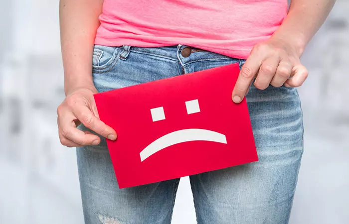 Woman with sad smiley on paper - foul smell concept