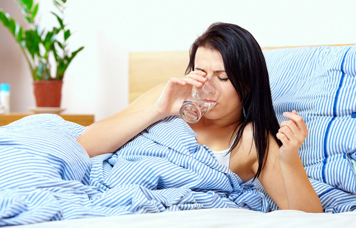 Woman drinking water to avoid tickle in throat
