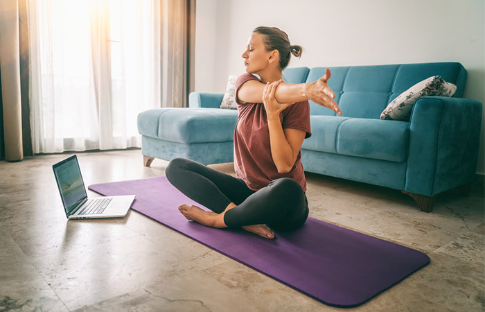 Woman practicing yoga to reduce obstructive sleep apnea 
