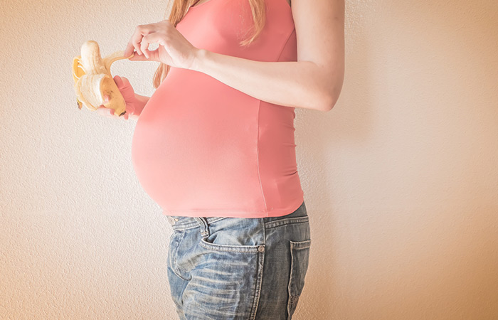 Pregnant woman eating banana for better digestion