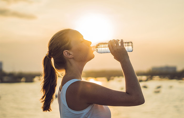 Woman drinking water to reduce blood sugar levels