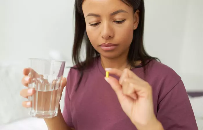 Woman taking OTC medicines to manage swimmer's ear