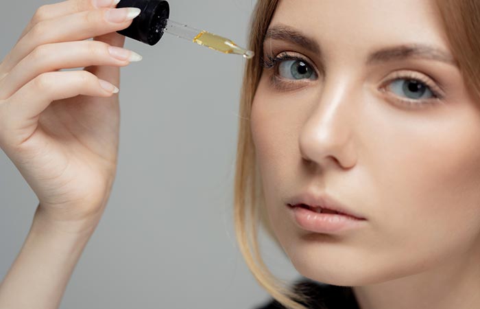 Woman using almond oil for dark circles