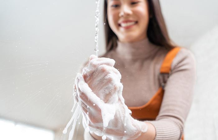 Woman washing hands frequently leads to dry skin
