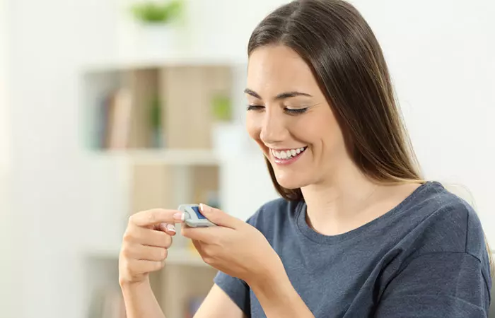 Woman checking her blood sugar level