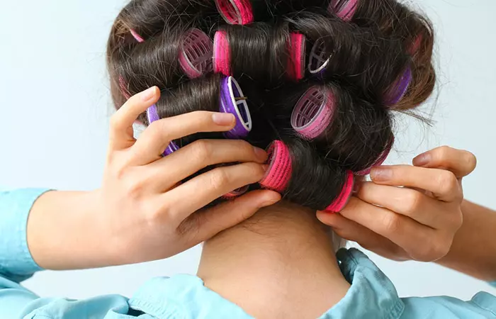 Woman removing rollers after they have cooled