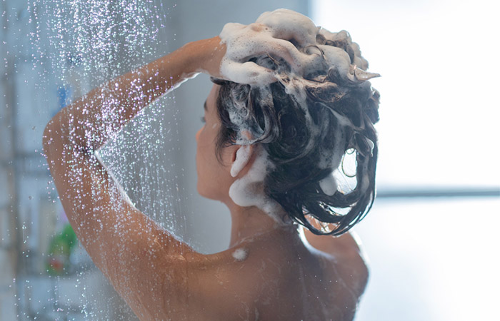 Woman washing hair a day before curling 