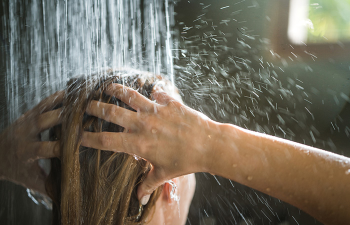 Woman washing her hair with water