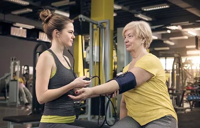 Woman getting blood pressure checked after excercise