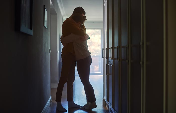 Emotional man hugging woman 